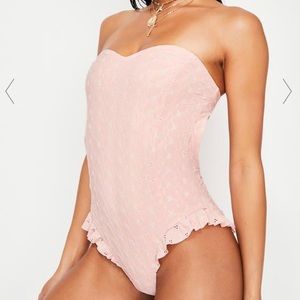 Pink eyelet one piece swimsuit with ruffle legs